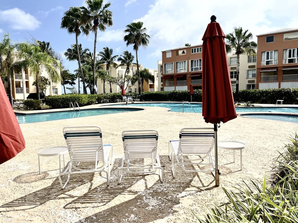 Pool chairs and umbrellas are provided.
