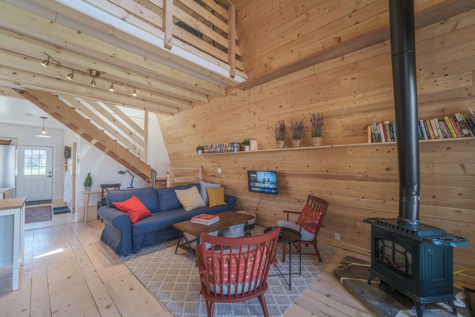 Living room couch has a pull out bed and has extra memory foam mattress