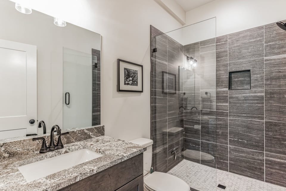 Spacious tiled shower in the basement bathroom.