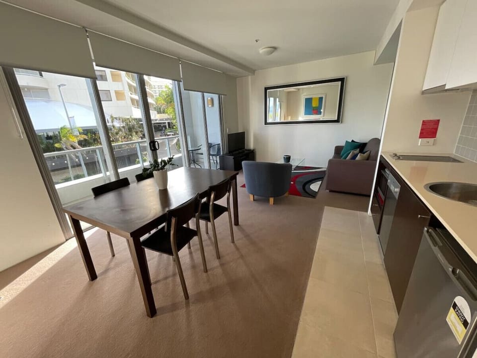 Open-plan living area featuring a dining table and natural light.
