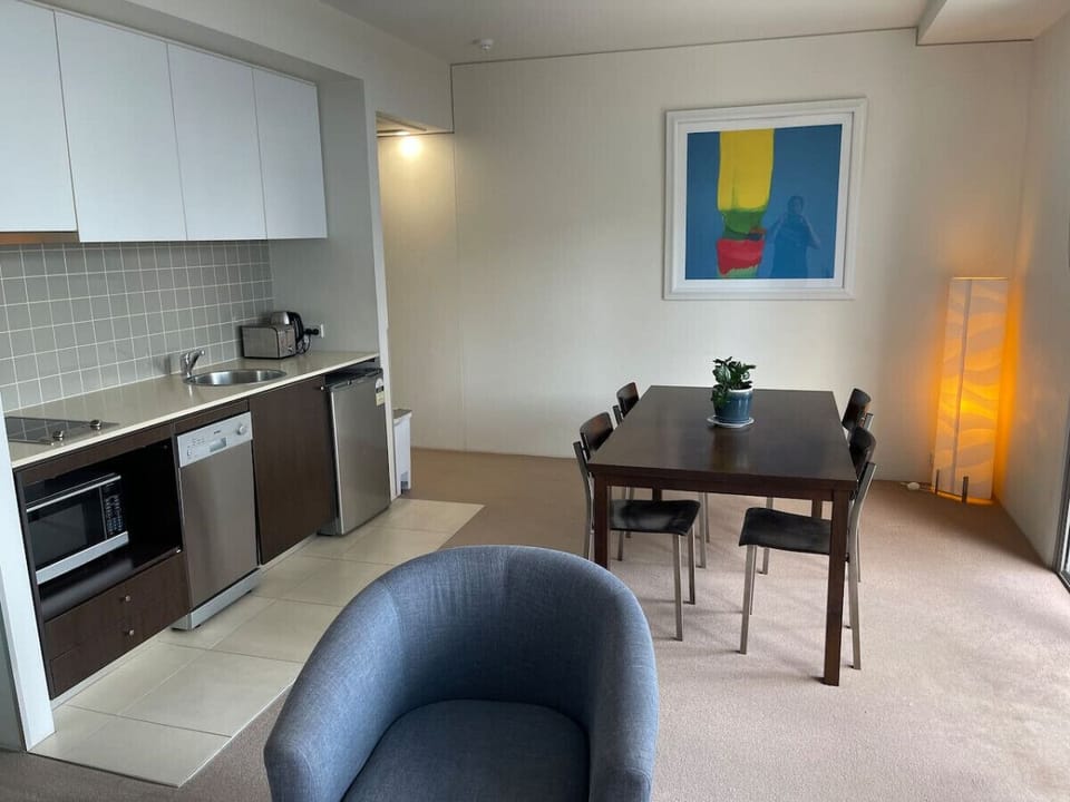 Modern kitchenette and dining area with appliances