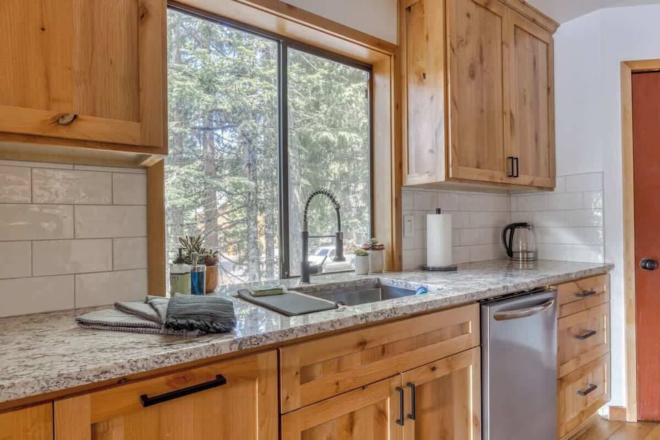 Sunny kitchen sink with a forest backdrop! Enjoy the view while prepping meals. 