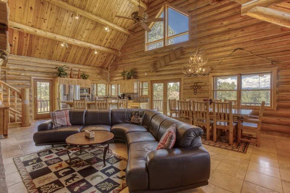 This wonderful living dining and kitchen space opens to a massive 2 story  fireplace. Ample seating for everyone, plus the views are amazing.