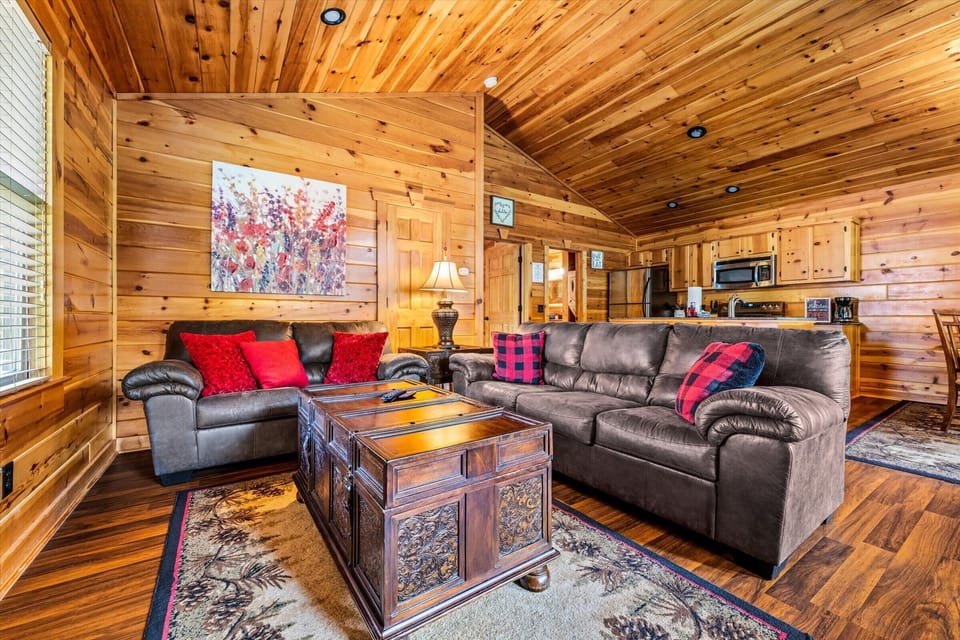 Open-concept living means everyone stays together — gather around the fire while the kitchen keeps the conversation going.