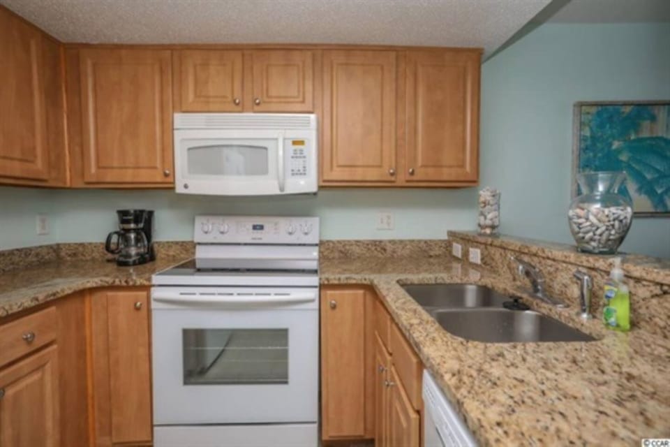 A well-equipped kitchen with modern appliances and a beach-inspired touch.