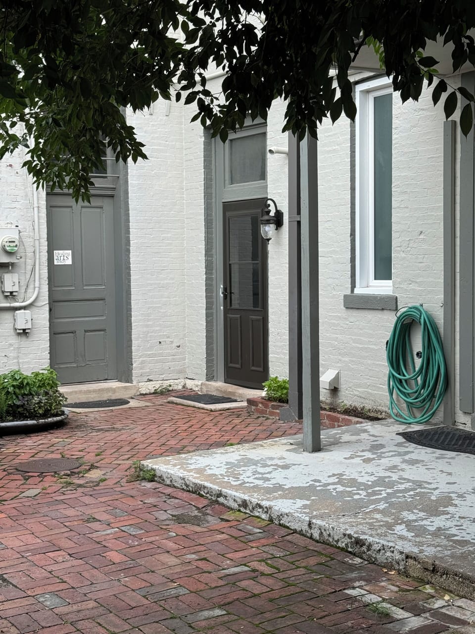 Enter through the corner door to the right of the sign that says healing arts.