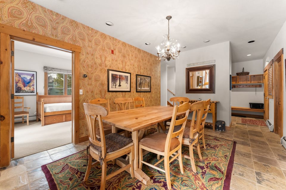 Gather around this warm wooden dining table where memorable meals and conversations await your family.