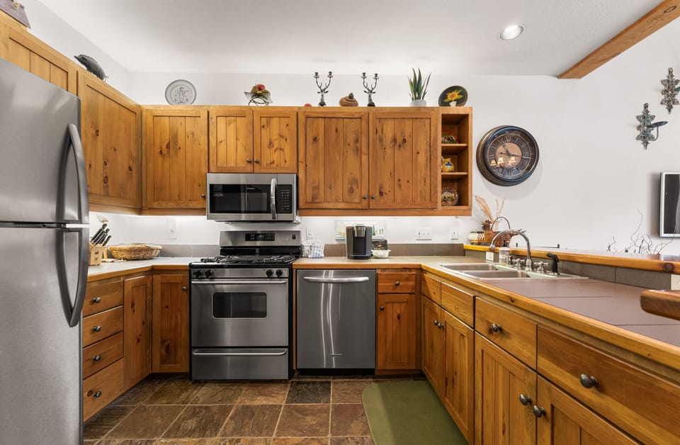 Your fully equipped kitchen features warm wood cabinets, stainless steel appliances, and everything you need to prepare memorable meals during your stay.