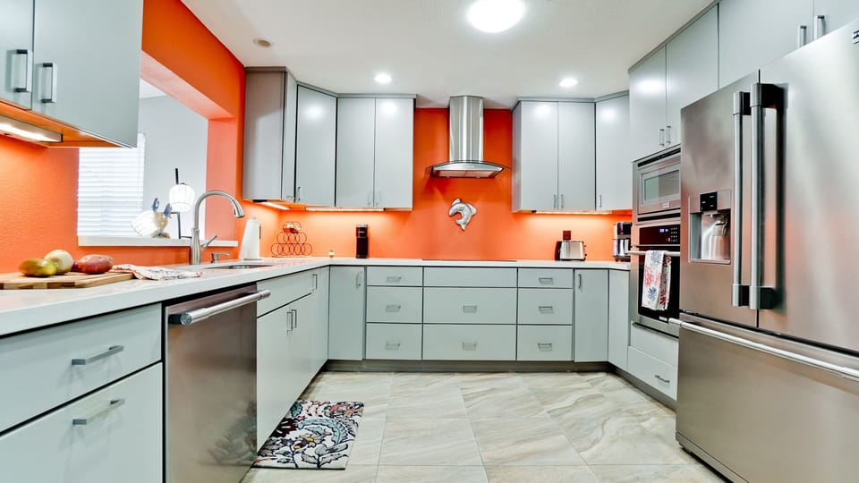 Modern fully stocked kitchen with stainless steel appliances.