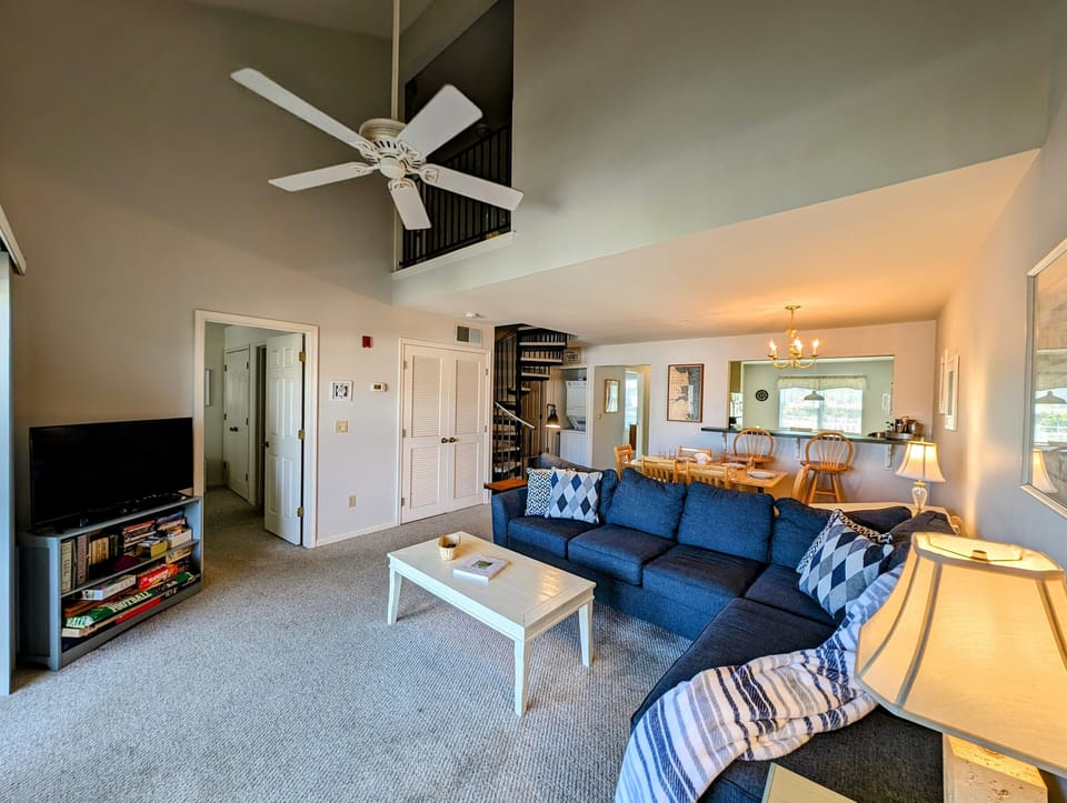 605 Crowley Drive - Airy Interior with Overlooking Loft - This perspective showcases the impressive vertical scale of the "penta" style floor plan, highlighting the spacious loft overlooking the great room. The open layout seamlessly connects the media area to the kitchen and dining spaces.