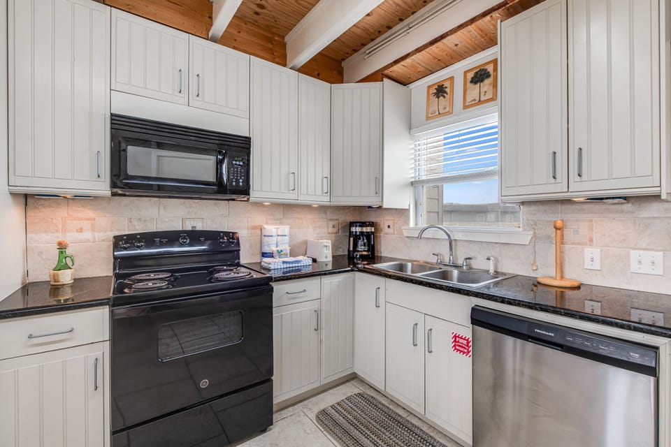 Prepare delicious meals in your fully equipped kitchen featuring modern appliances, granite countertops, and plenty of cabinet space.