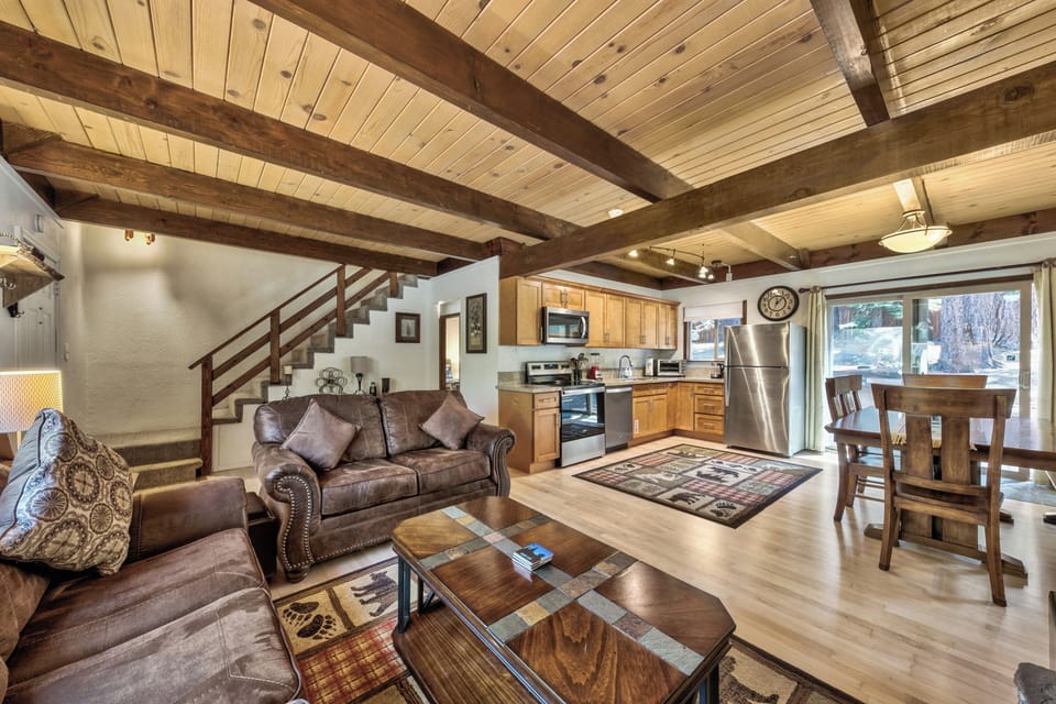 Relax in this stunning open-concept space where rustic exposed beams frame your mountain retreat. The kitchen awaits your culinary adventures.