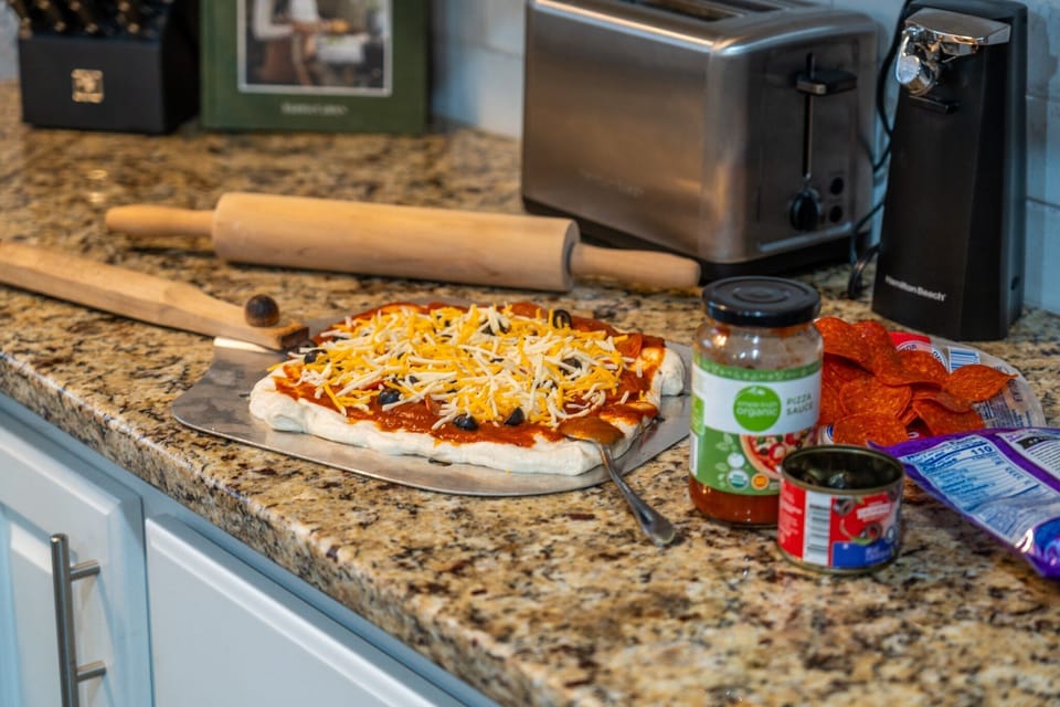 Roll out the dough and load it however you like — pizza night here starts on the granite and ends on the deck.