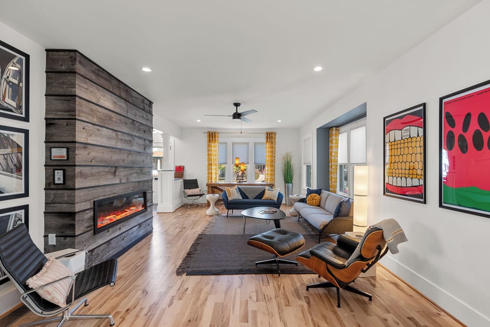 Ultra high-end MillKnoll seating anchors the living room with comfort and clean, modern lines.