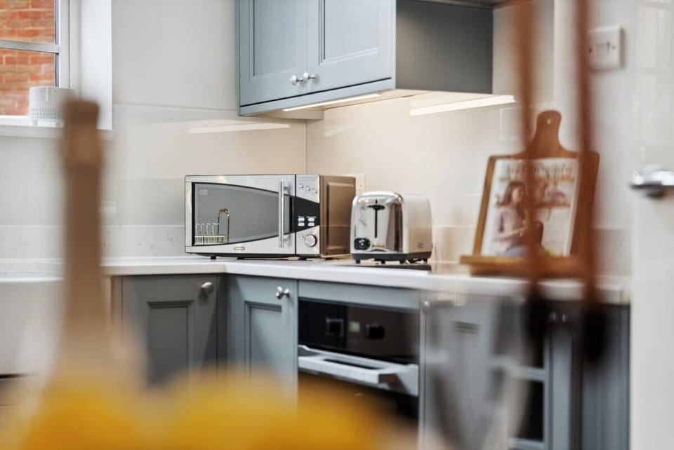 Whip up a home-cooked meal with family in the fully equipped kitchen and dining area at Blue Puffin Stays  Short Lets & Serviced Accommodation