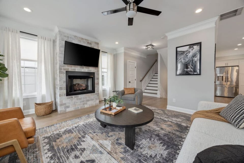 The living room connects naturally to the kitchen and staircase.