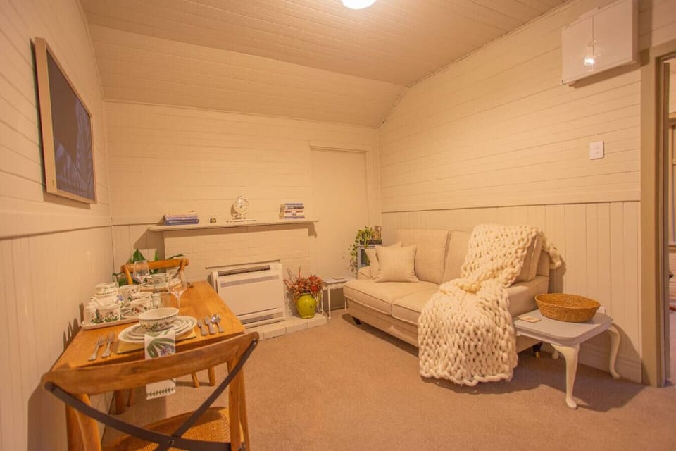 Settle in with your loved one in this cozy retreat—curl up on the sofa, share an intimate dinner at the wooden table, and feel the warmth of genuine comfort.