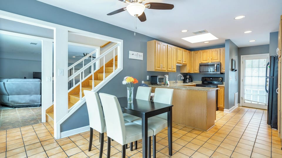 The table offers a comfortable spot for quick breakfasts, snacks between pool sessions, or a quiet place to plan the day's adventures.