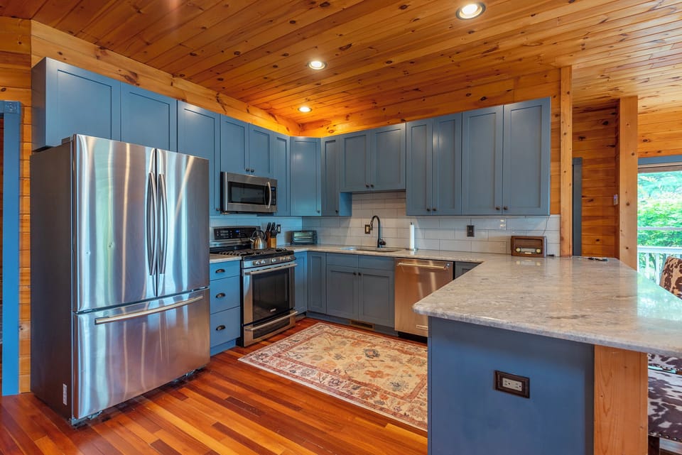 Well-equipped kitchen with dishwasher, kettle, and drip-style coffee maker