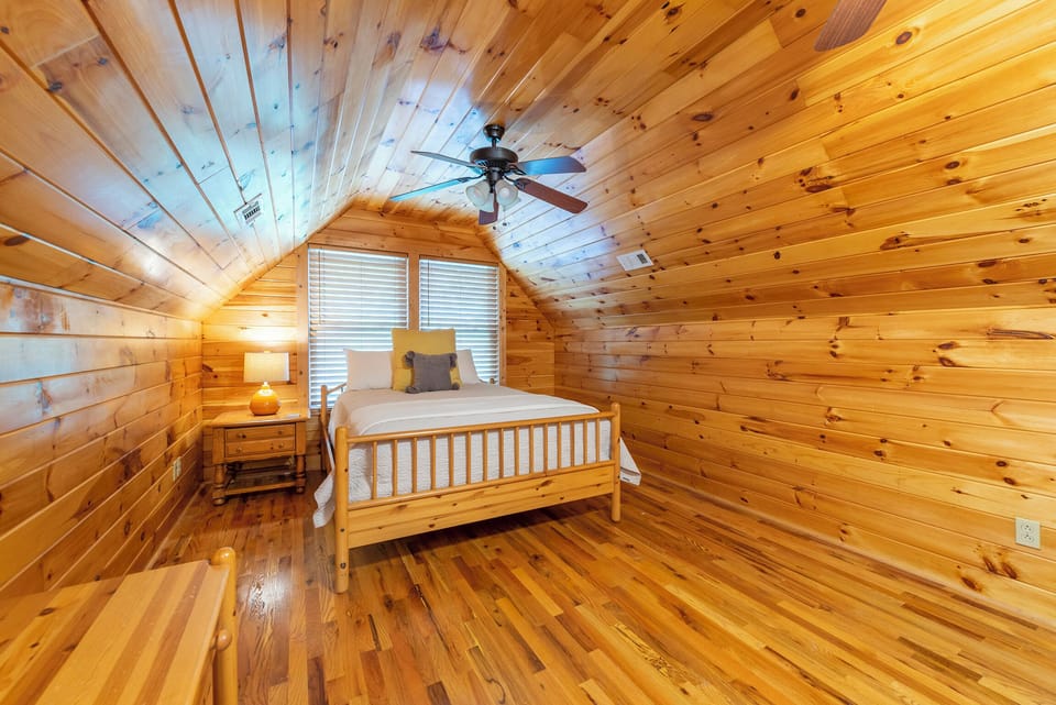Upper-level bedroom with one twin-size bed and one queen-size bed