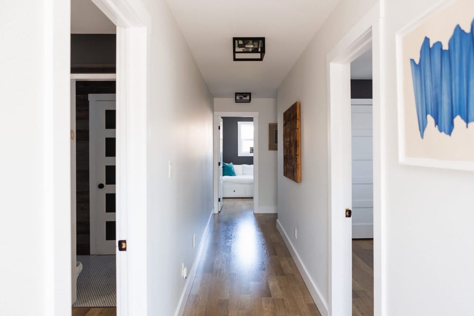 Upstairs Hallway: Primary Bedroom Suite on the Left, Bathroom on the left, two more bedrooms down the hall, the office and hidden secondary living room/playroom.