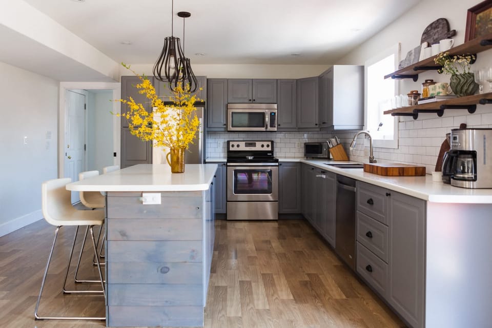The kitchen is off the dining area + steps from the beautiful backyard oasis.