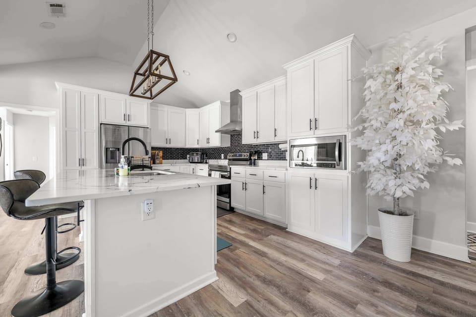 The industrial-chic kitchen amenities, like the stainless steel dishwasher and toaster, are just a reach away for ultimate convenience.
