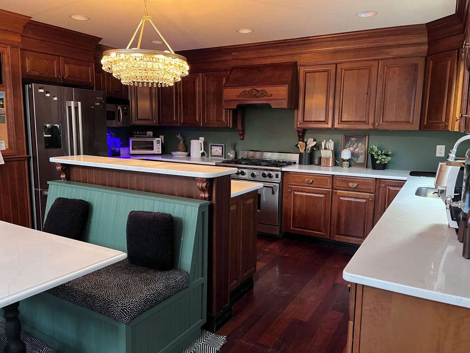 Kitchen. Wolf stove, beverage fridge, banquette seating. 
