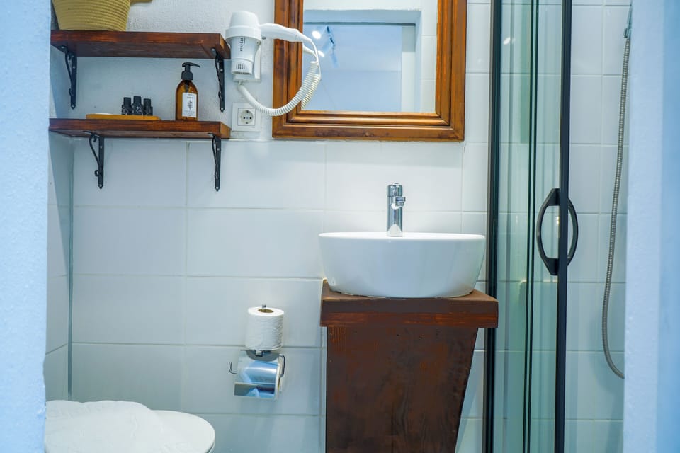 Shower, hair dryer, slippers, towels