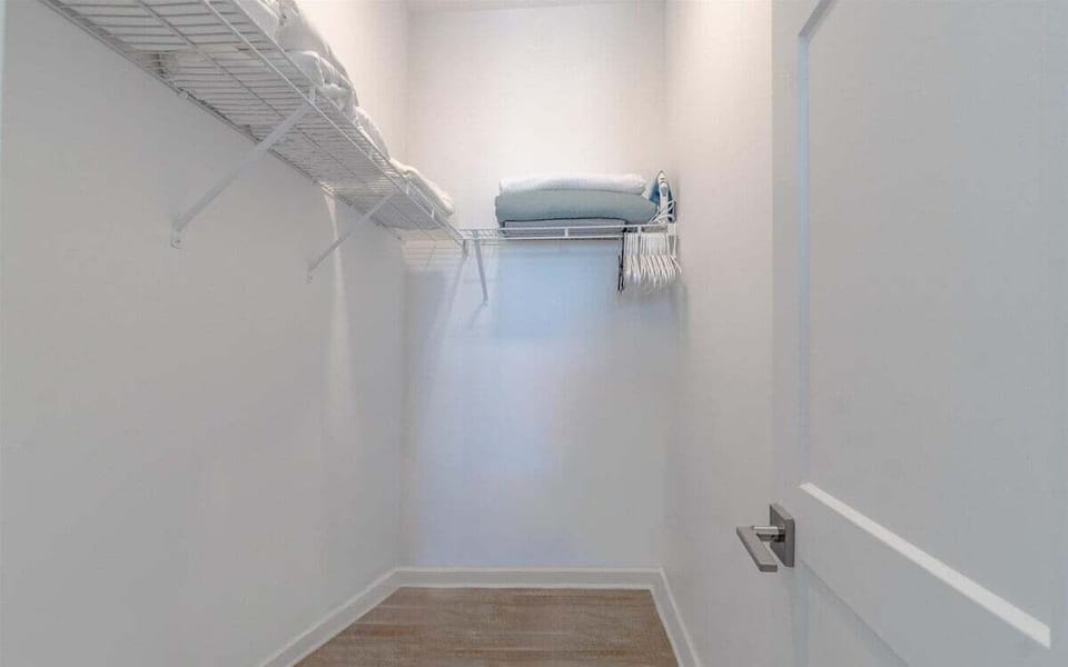 Large walk-in closet with plenty of hanging space and storage for extended stays.