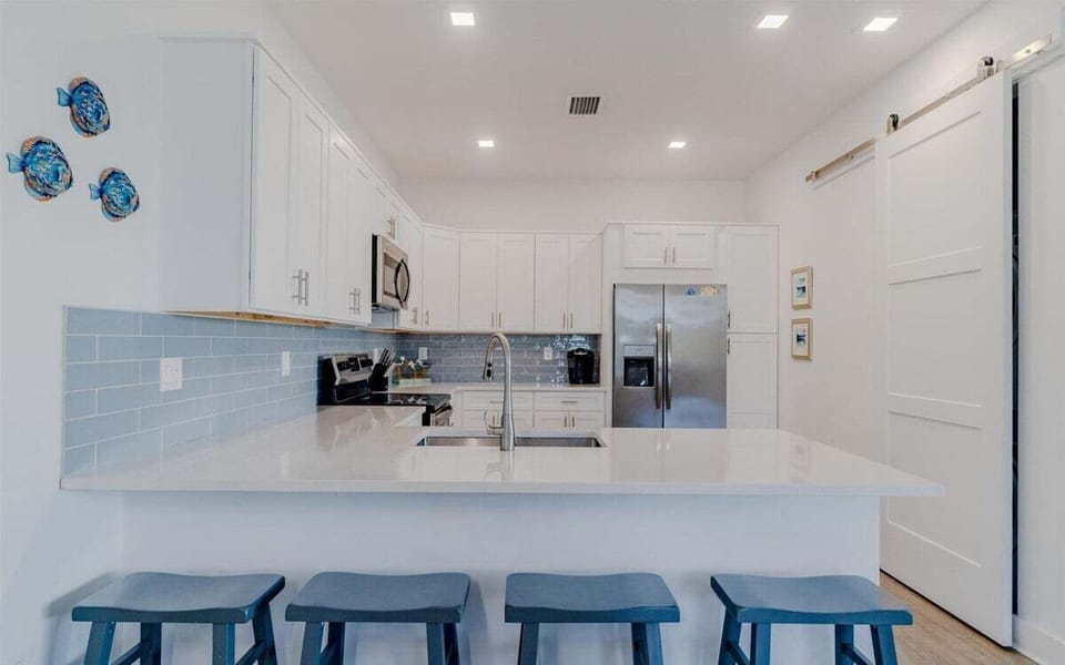 Large center island with seating for four, ideal for entertaining and casual dining.