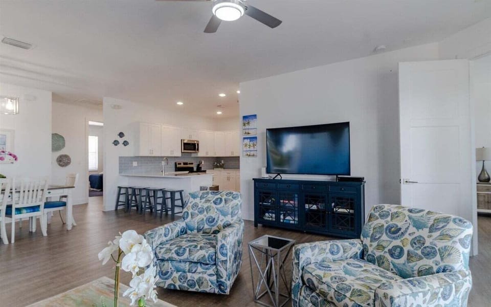 Charming living room decor with comfy seating arrangement and smart TV.