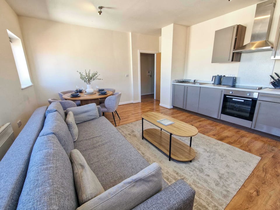 Kick back on the comfy sofa after a day exploring Manchester, with the kitchen just steps away