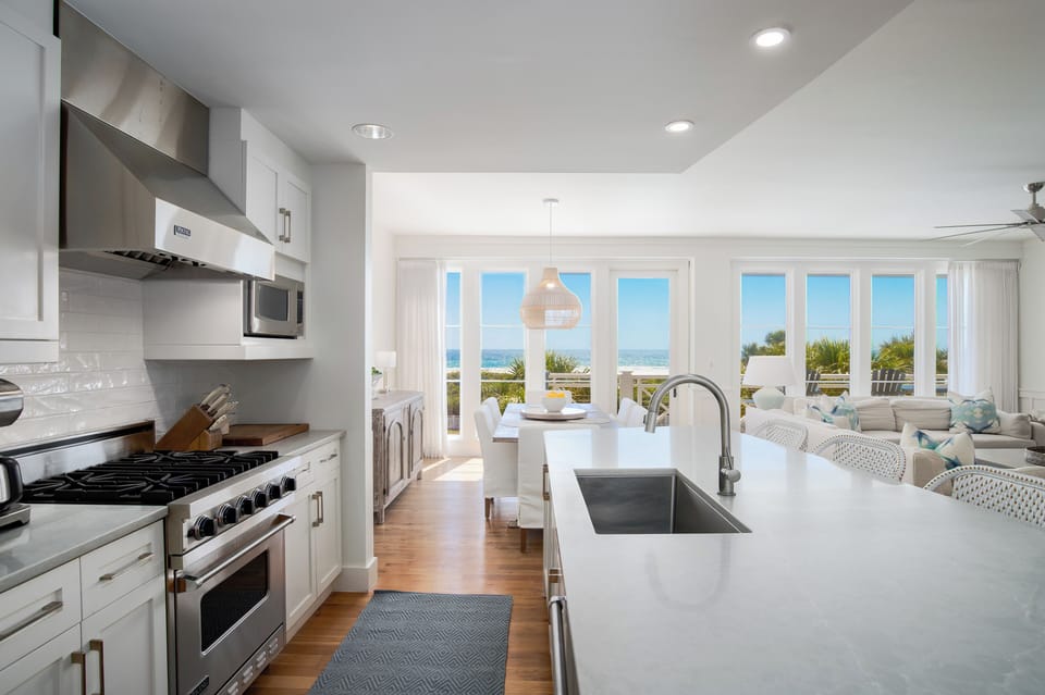 Your modern kitchen seamlessly flows into the living area, where stunning ocean views await through floor-to-ceiling windows.