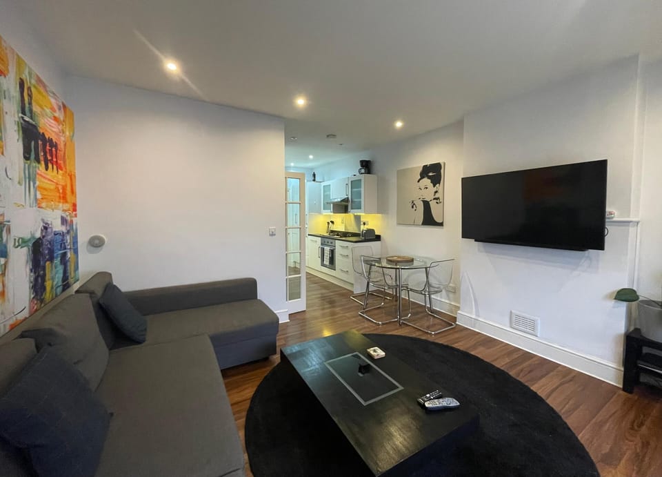 View of spatious living room with sofa bed and 55" smart tv