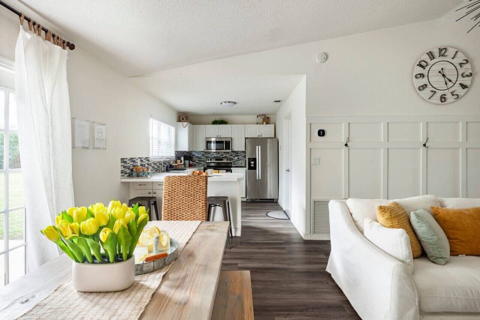 Bright open-concept space with modern kitchen, cozy seating, and natural light.