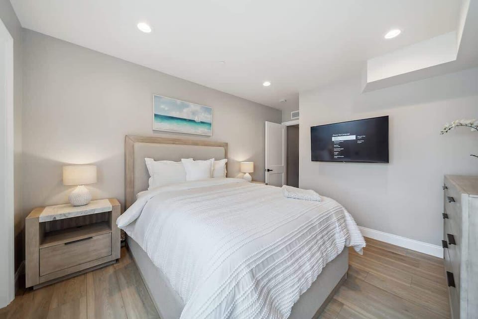 Plush bed and wall-mounted TV