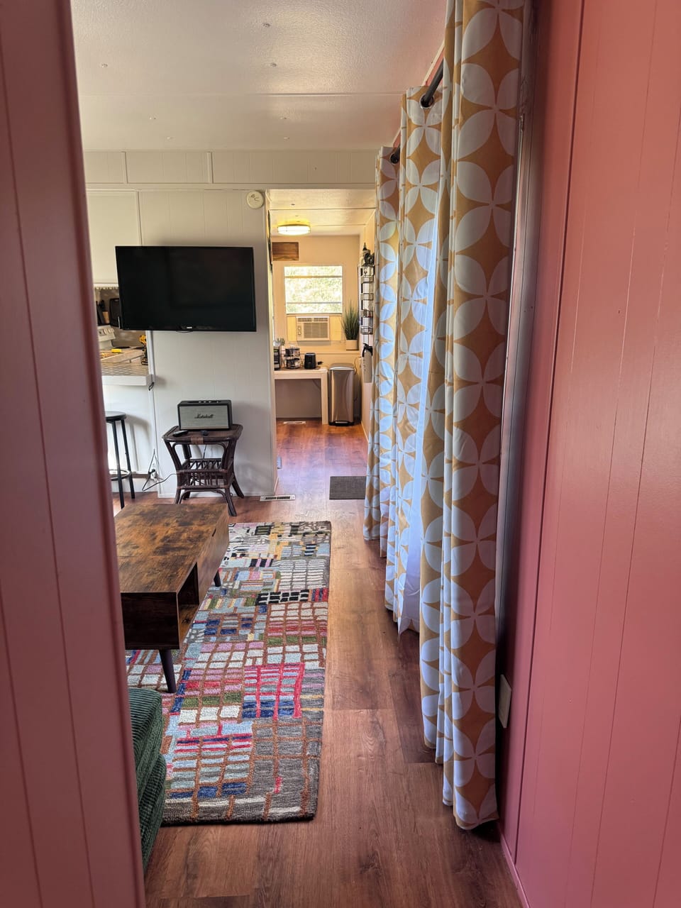 Hallway view connecting living area to kitchen and bedrooms.