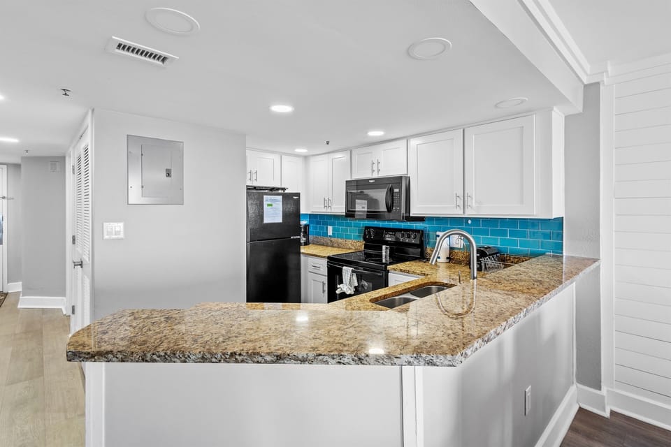Large kitchen with granite countertops