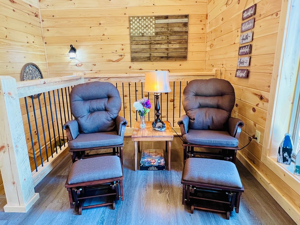 Cozy sitting nook with two plush accent chairs perfect for reading or relaxing at A Tyme to Chill cabin in Wears Valley, Tennessee.