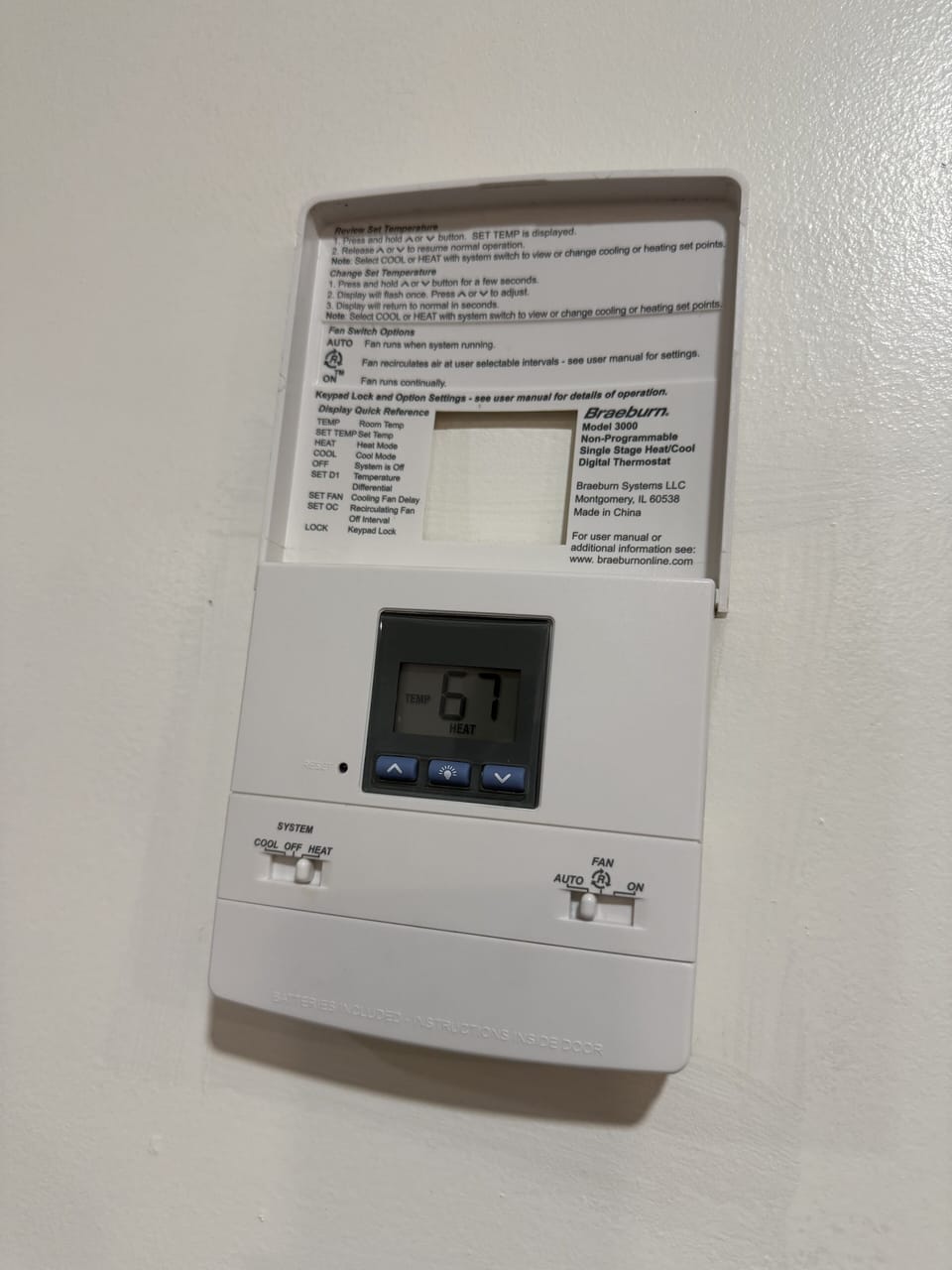 Adjust room temperature via the thermostat on the wall behind the dining table.