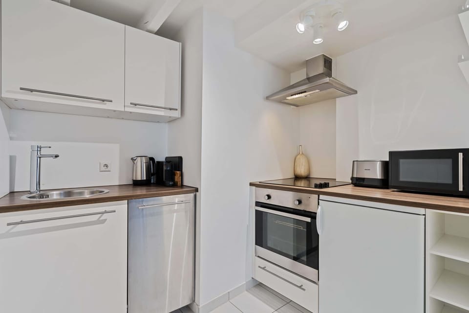 Well-equipped kitchen featuring a stove, microwave, and ample counter space for your culinary needs.