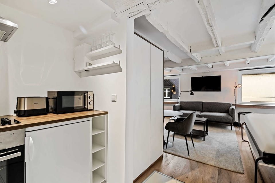 Open-concept kitchen and living area with modern appliances and comfortable seating.