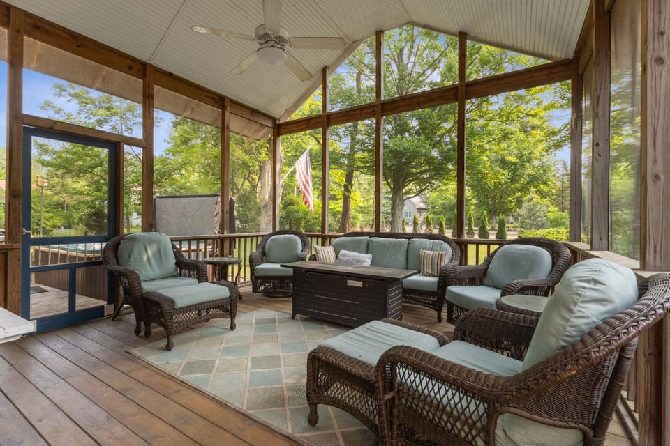 Cozy screen porch with TV and fire table