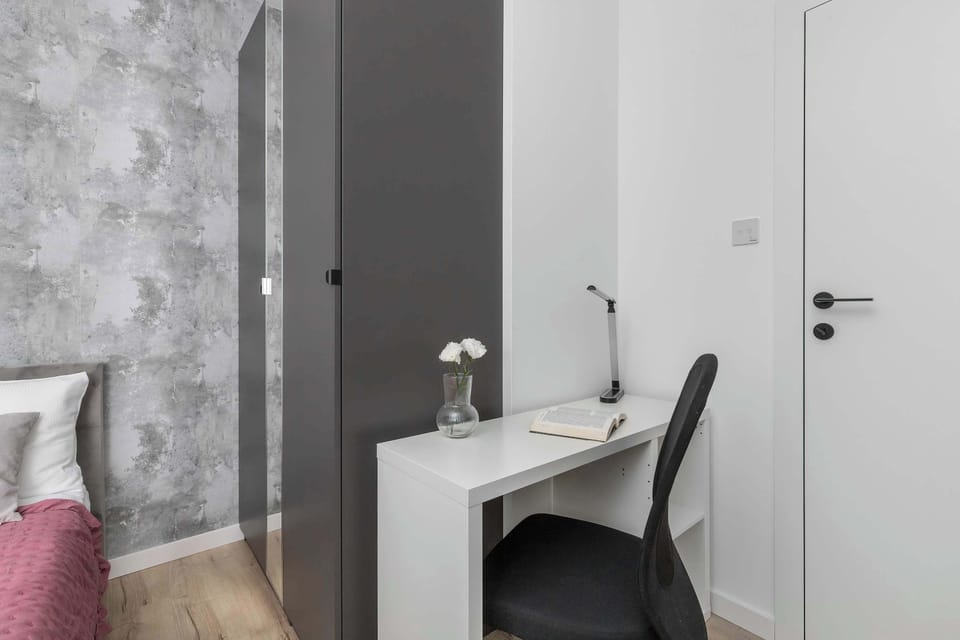 The bedroom's tasteful decor combines functionality with elegance. 