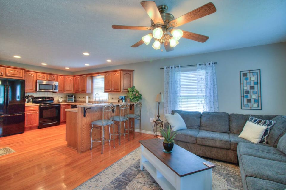 Cozy living room with a plush sofa and a charming view of the kitchen.
