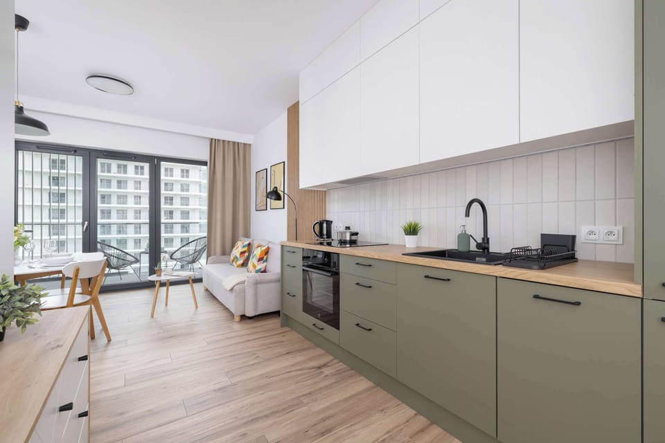 The sleek design of the kitchenette blending seamlessly with the living area.
