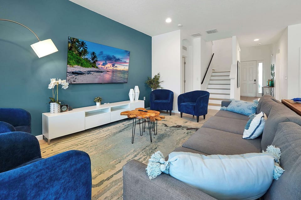 Unwind in our inviting living room, offering ample seating, a large smart TV, and stylish decor