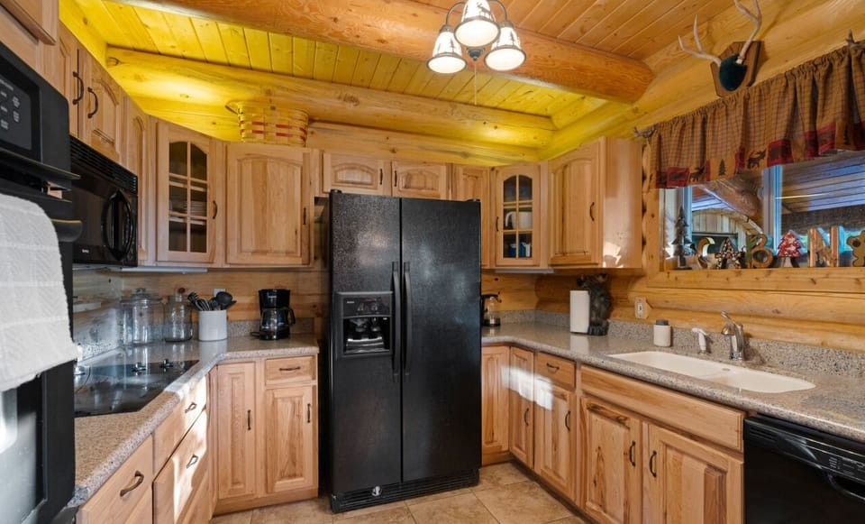 Unleash your culinary creativity in the fully equipped kitchen featuring a custom-built 10-foot dining table where you can enjoy meals with breathtaking panoramic mountain views.