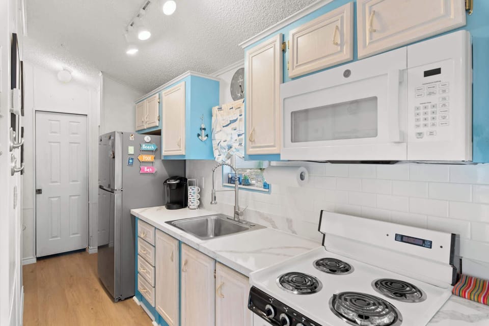 Cook up coastal meals in the cheerful, fully equipped kitchen